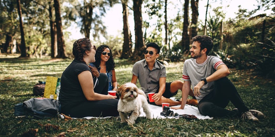 Person sharing a funny story with a group, everyone laughing and engaged.